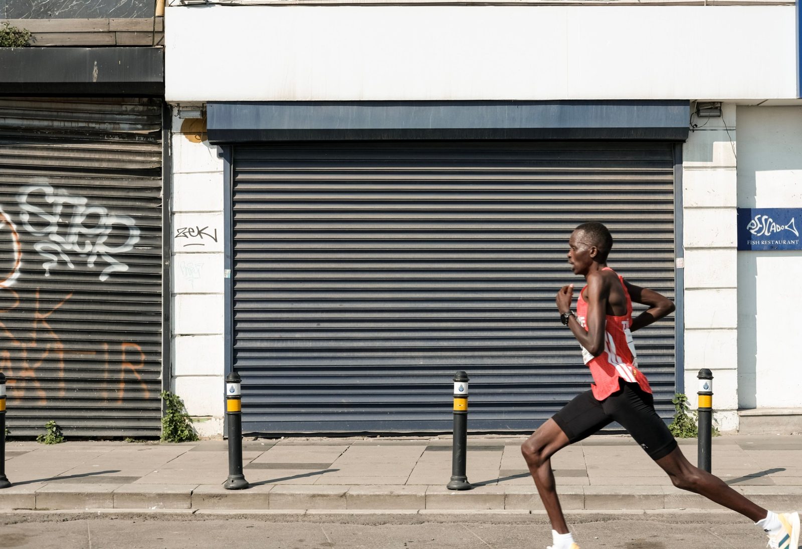 A distance runner racing along a city street